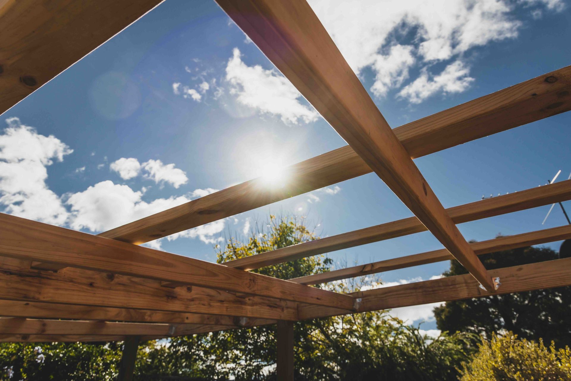 The sun is shining through the roof of a wooden structure.