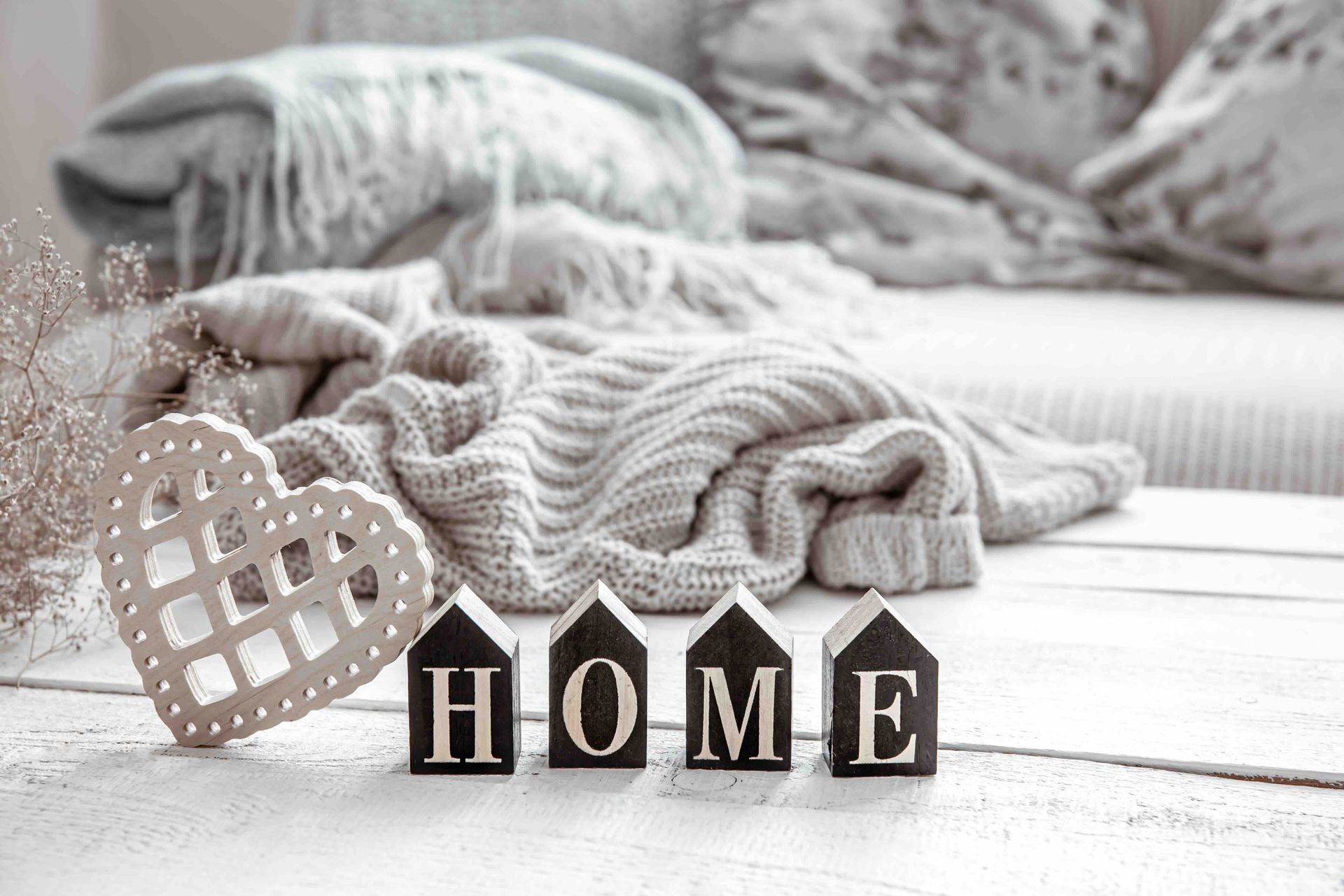 Cozy scene with a knitted blanket, decorative heart, and 
