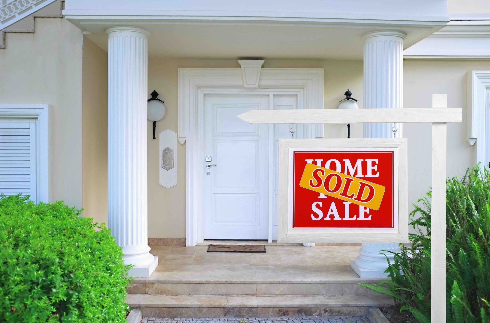 A house with a sold sign in front of it