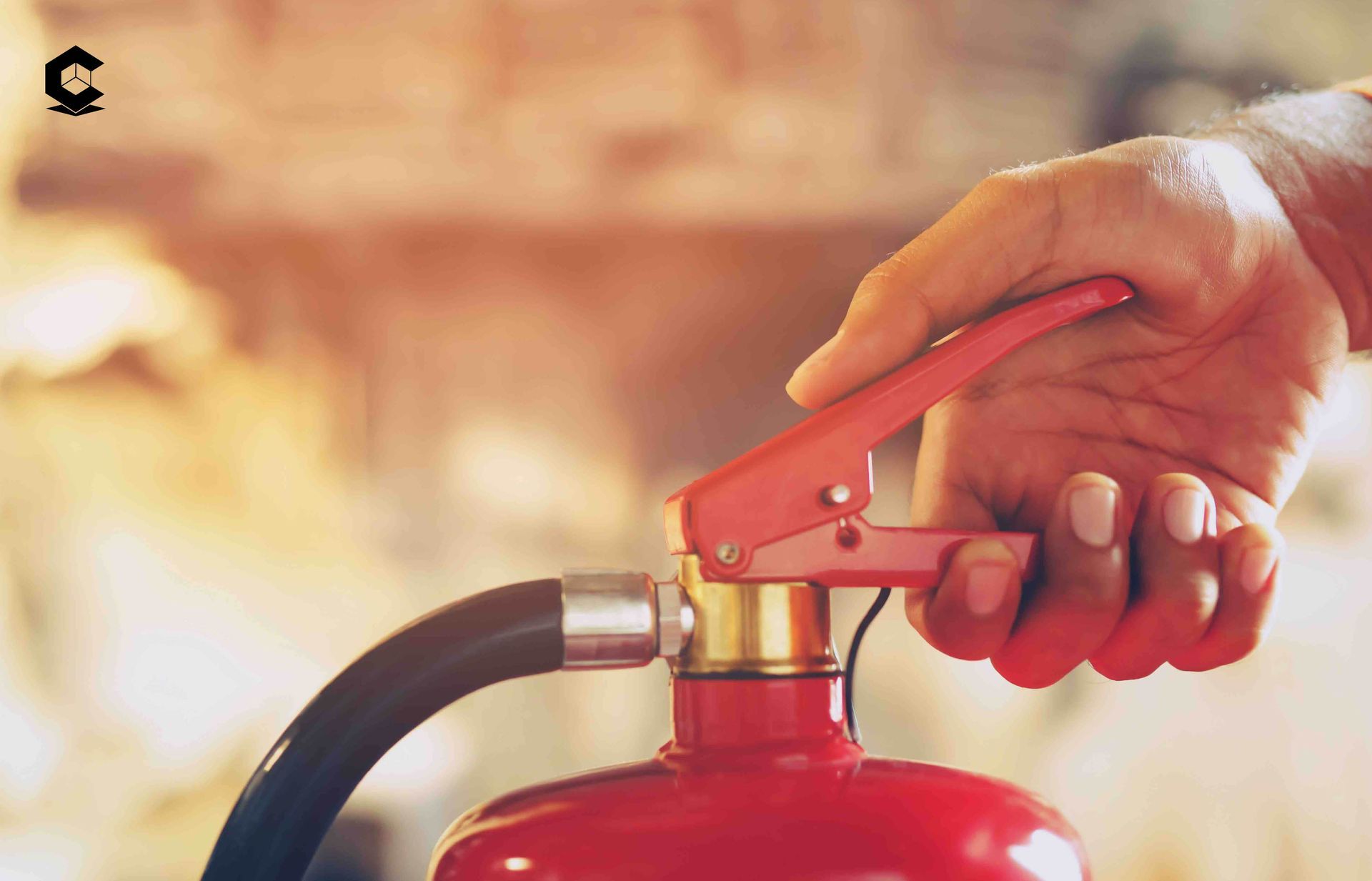 a person is holding a red fire extinguisher in their hand