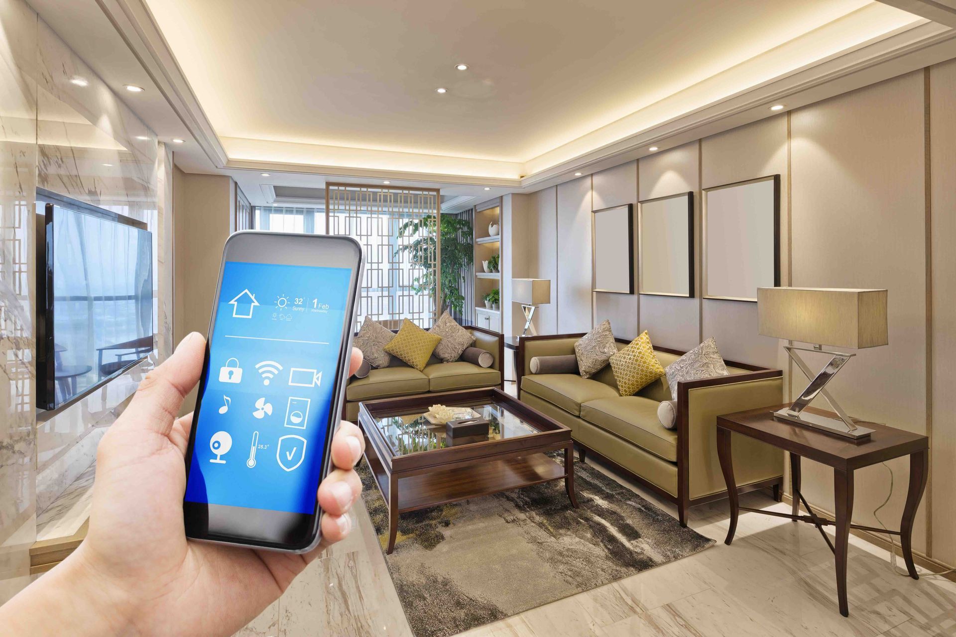 A person is holding a smart phone in a living room.