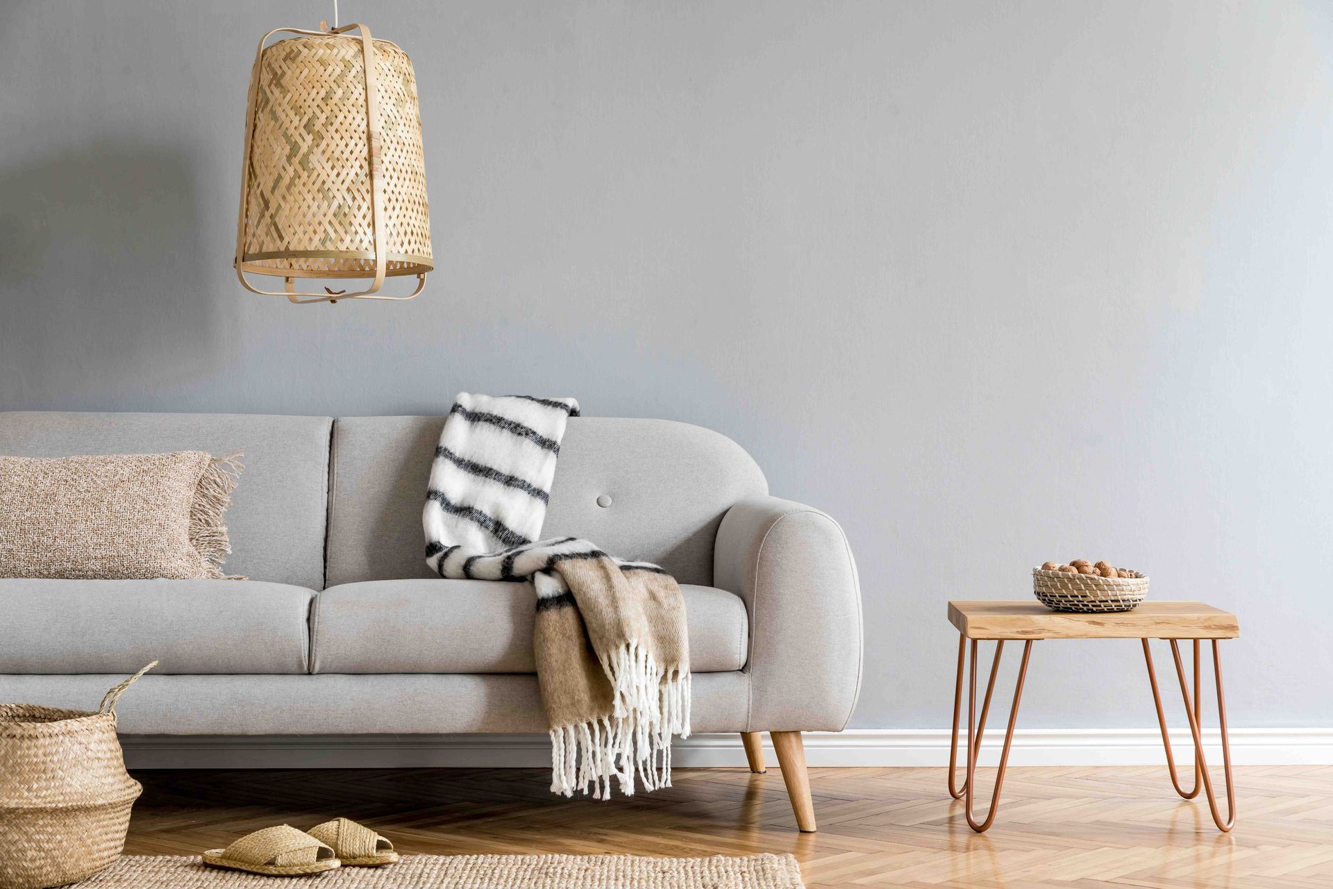 A living room with a couch, table, and lamp.