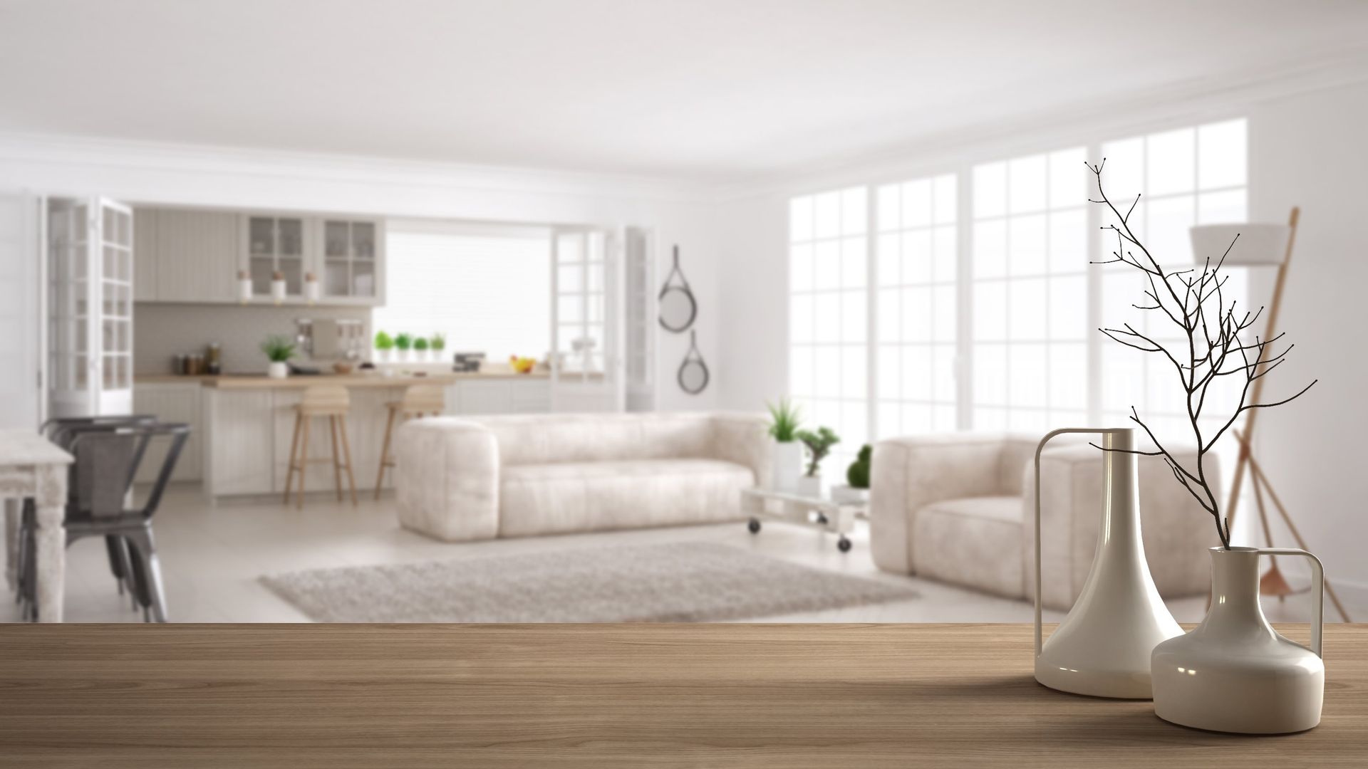 A wooden table with vases on it in front of a living room.