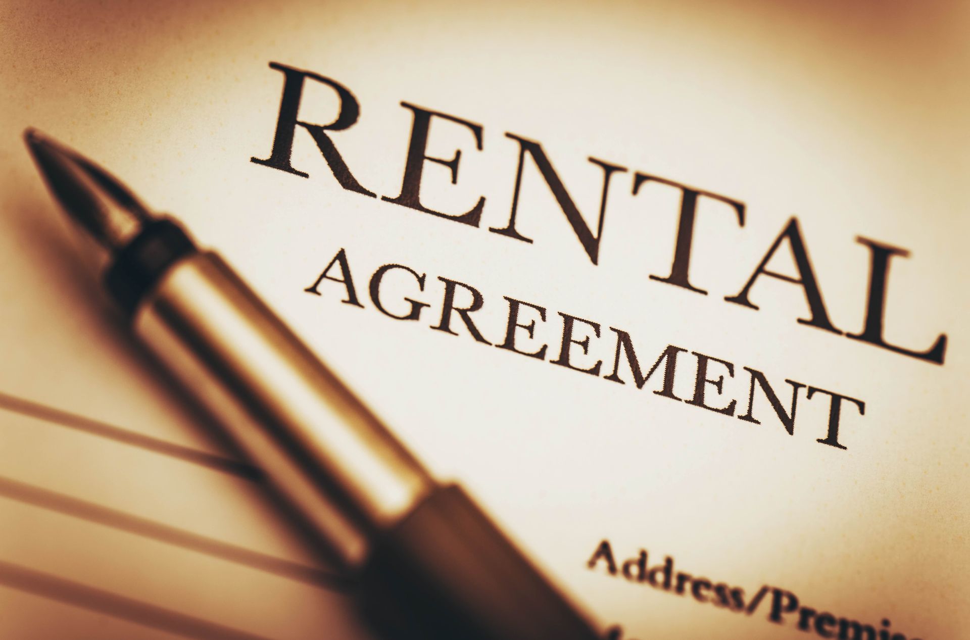 Rental agreement document with a pen.