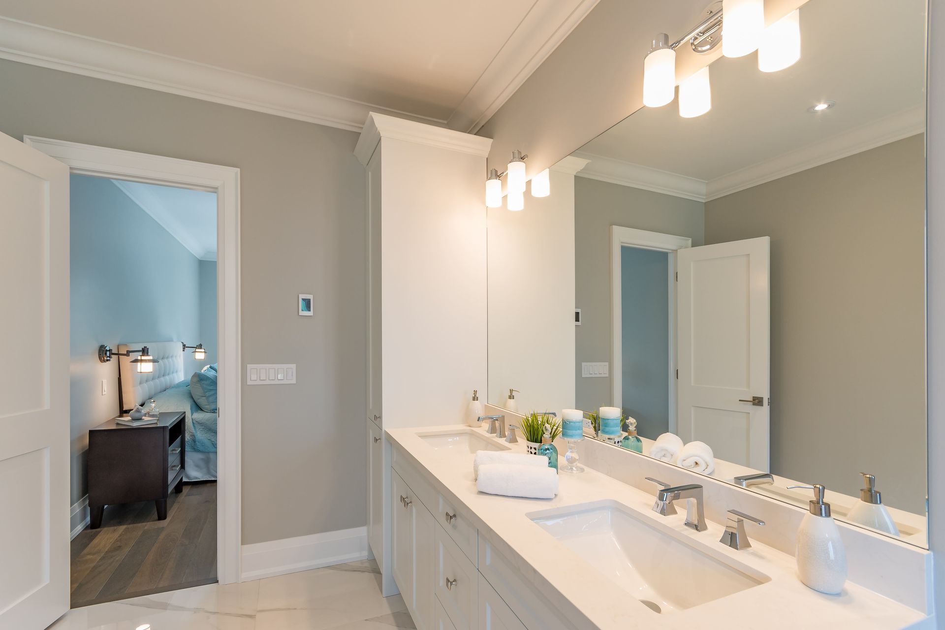 A bathroom with two sinks and a large mirror.