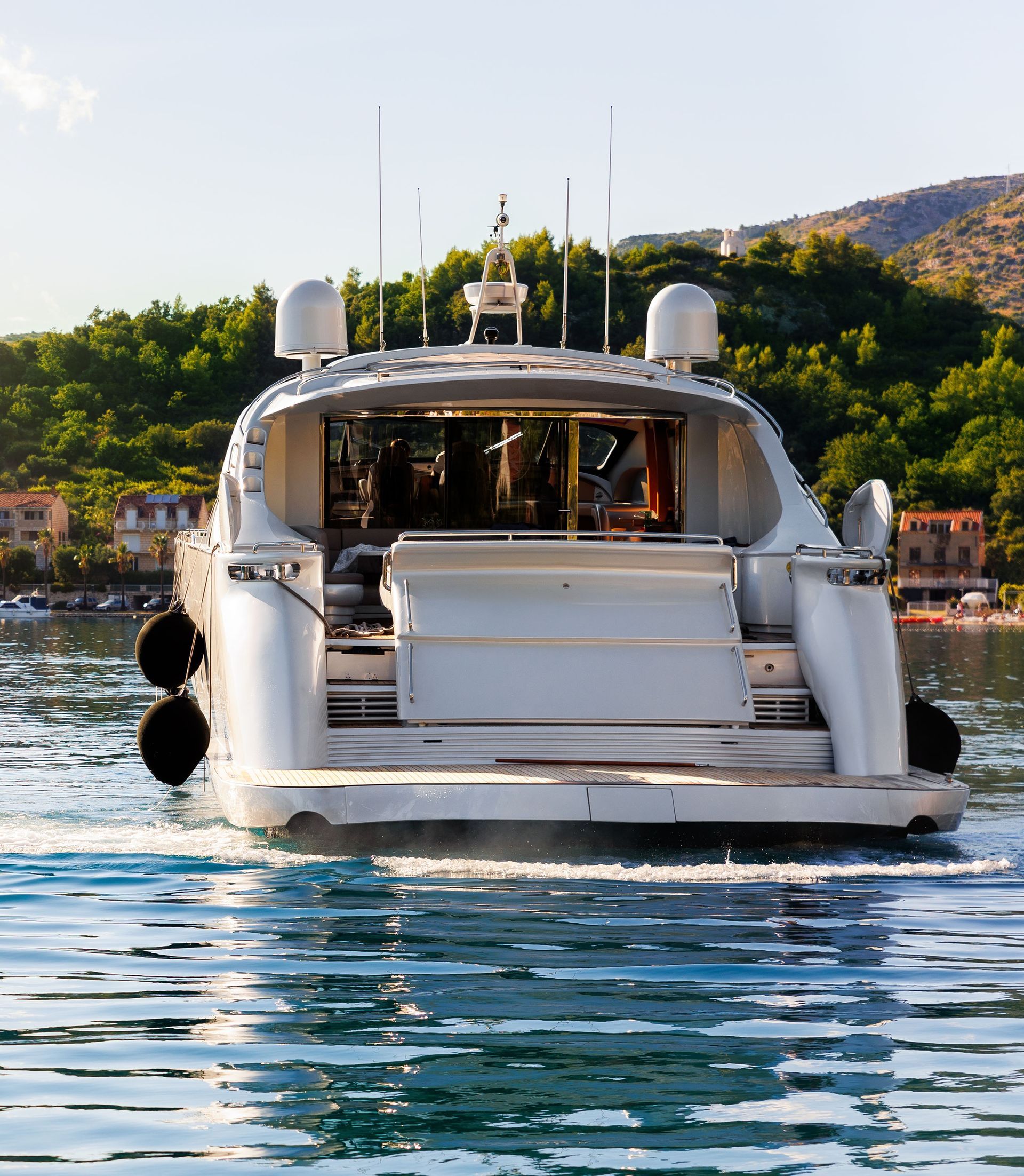A large white boat is floating on top of a body of water.
