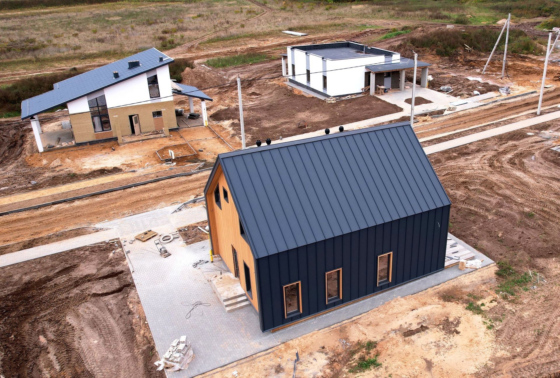 An aerial view of a house under construction in a field.