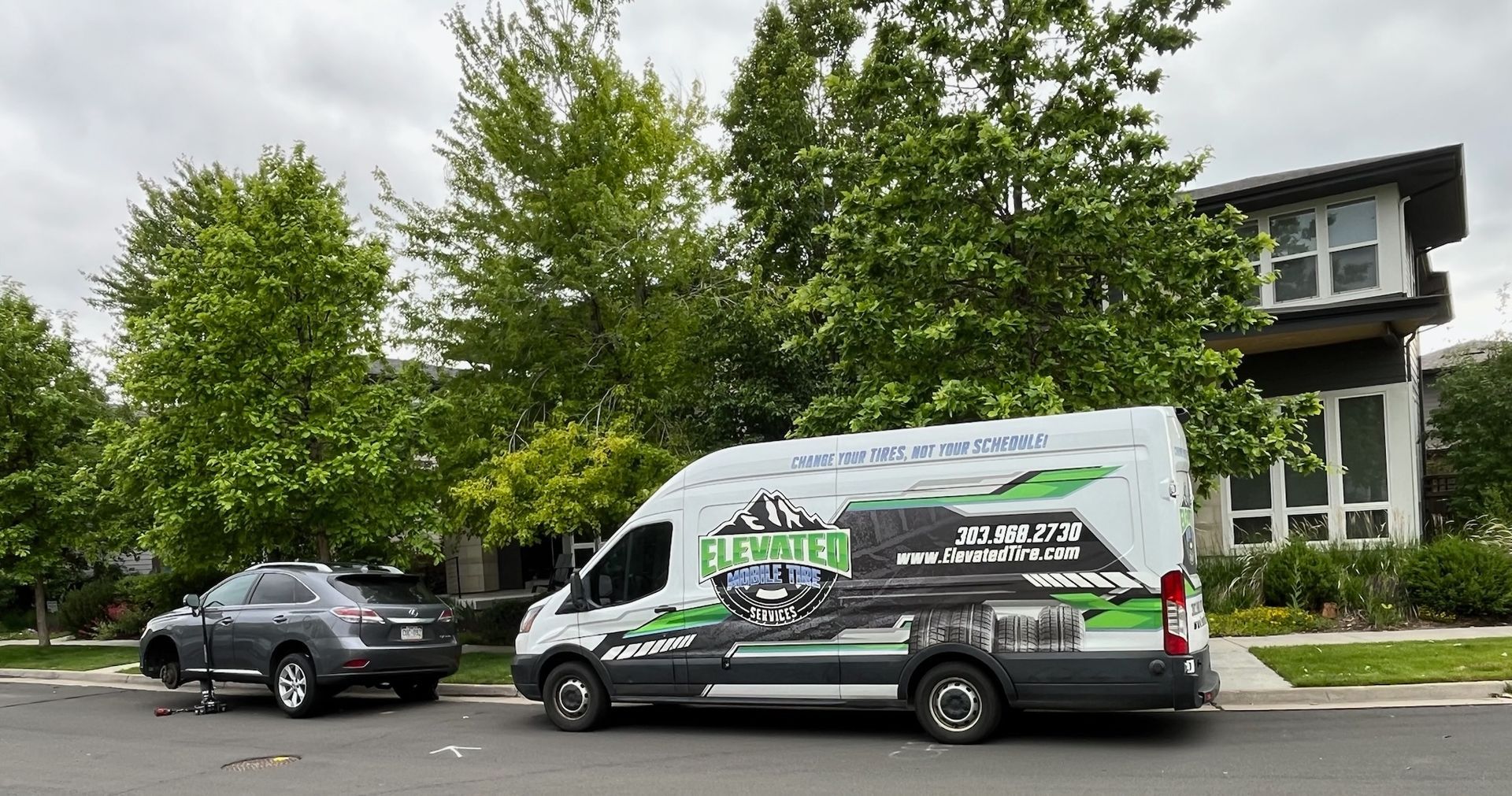 A van parked in front of a house has a 