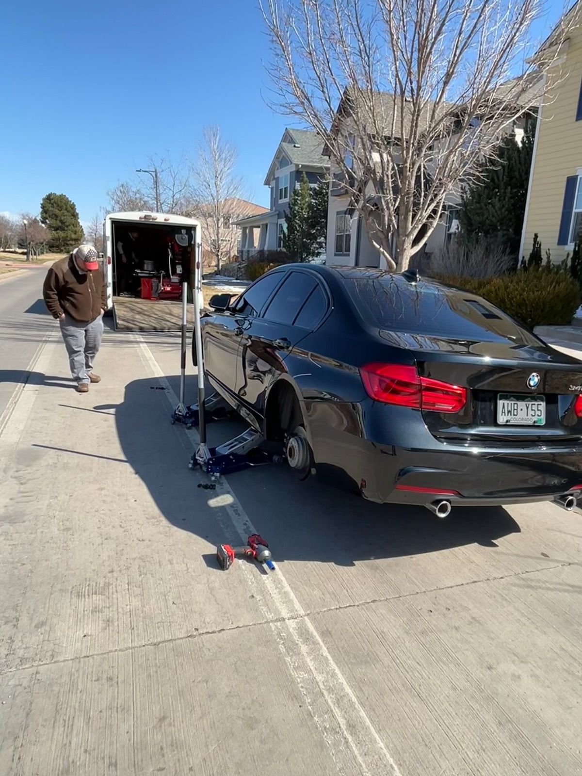Mobile tire repair at Elevated Tire trailer on the street.