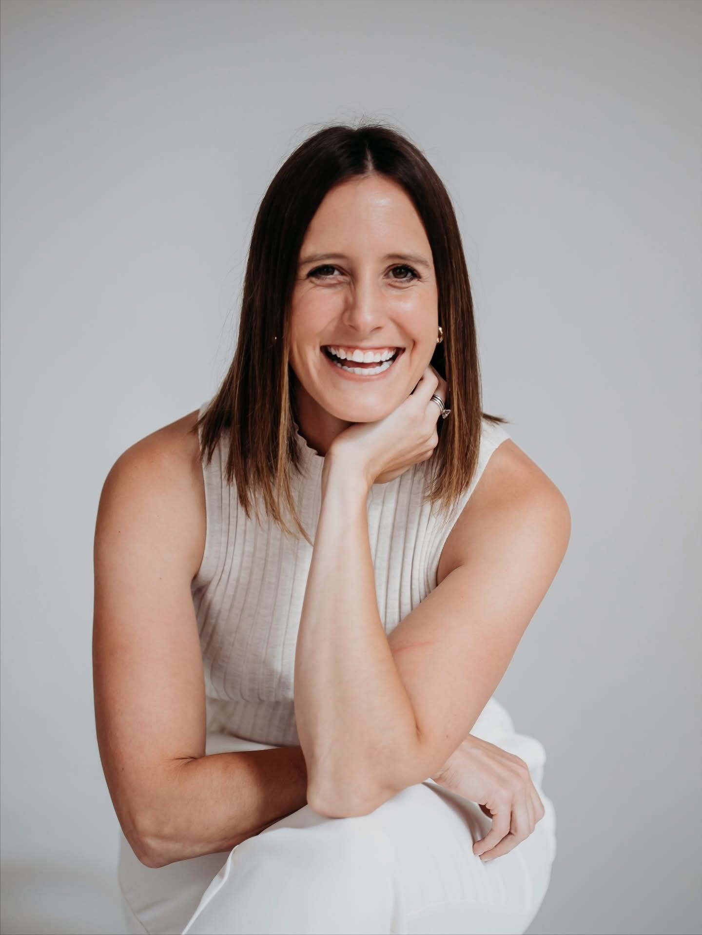 Woman with shoulder-length brown hair laughs