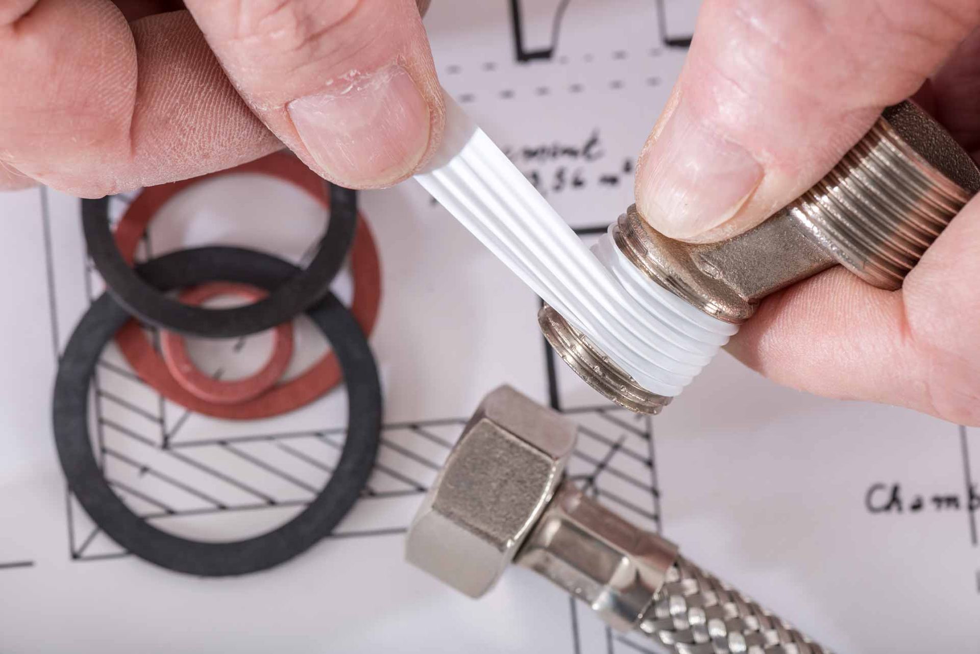 Expert commercial plumber using heavy-duty Teflon tape on plumbing fixtures.