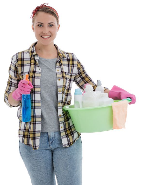 A house cleaning pointing a spray bottle forward while confidently holding a cleaning materials.
