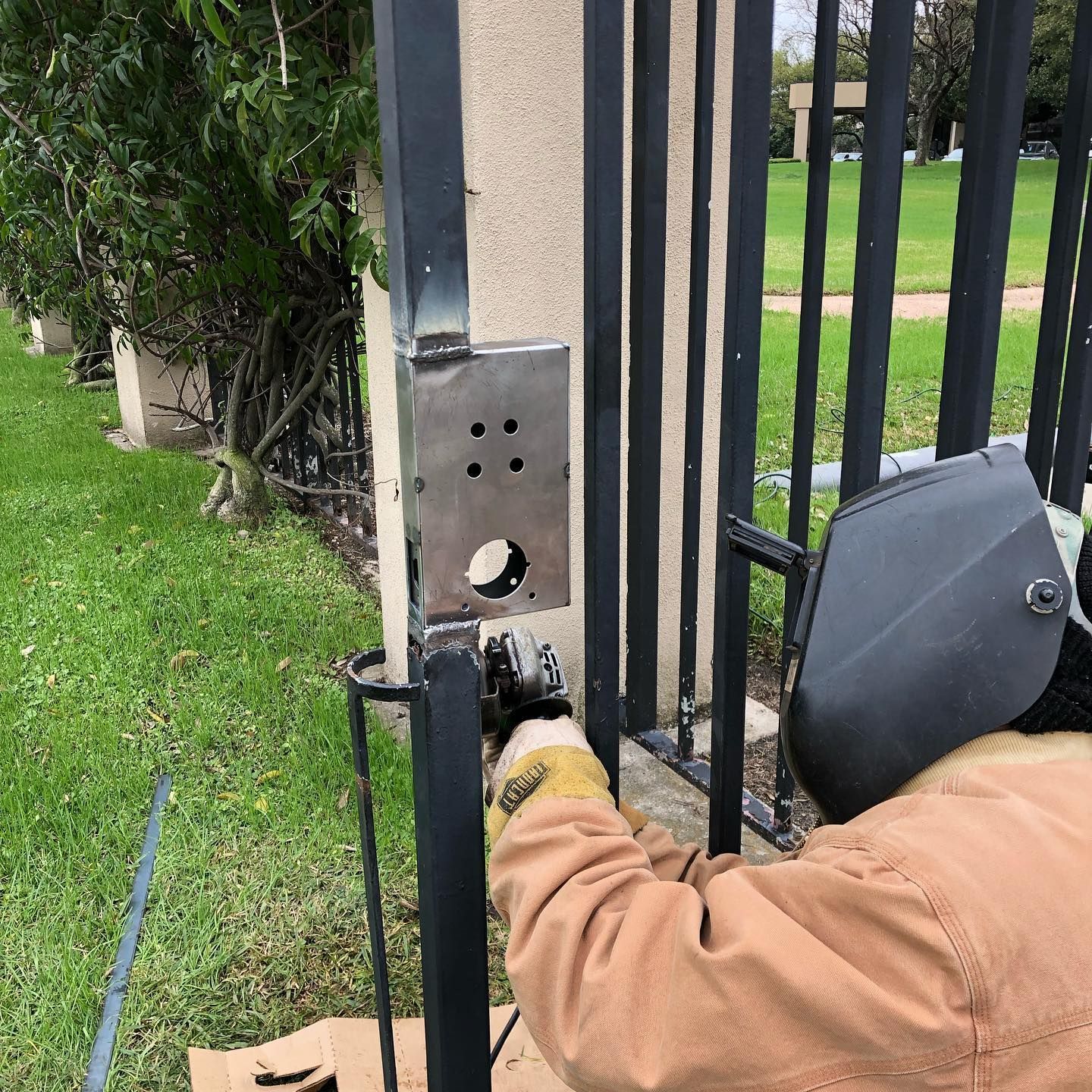 Knapp lock and Safe: Expert locksmith meticulously repairing a steel gate door, ensuring optimal security with specialized tools and skills.