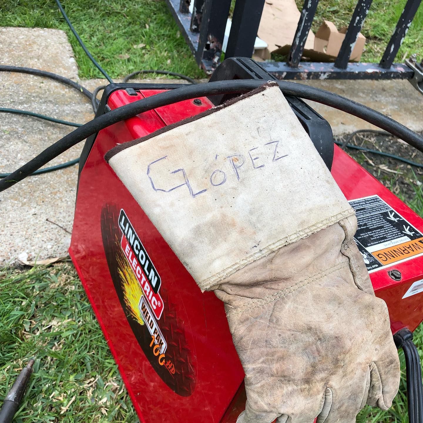 Knapp lock and Safe: Close-up of a locksmith's working gloves resting on top of a set of machine equipment, showcasing the tools of the trade for professional locksmith services.