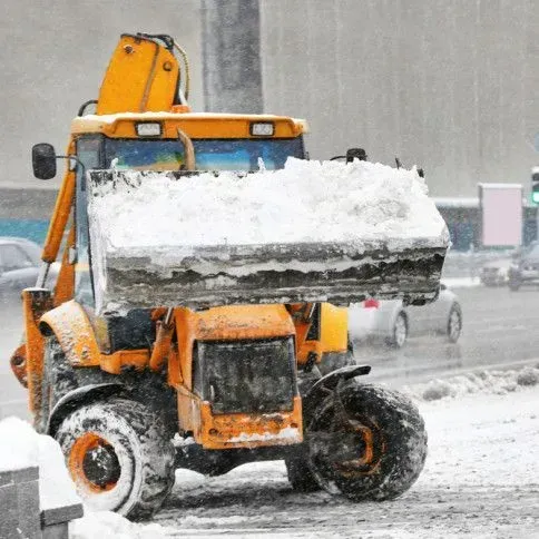 Snow plow at work on residential street in Spencer, MA