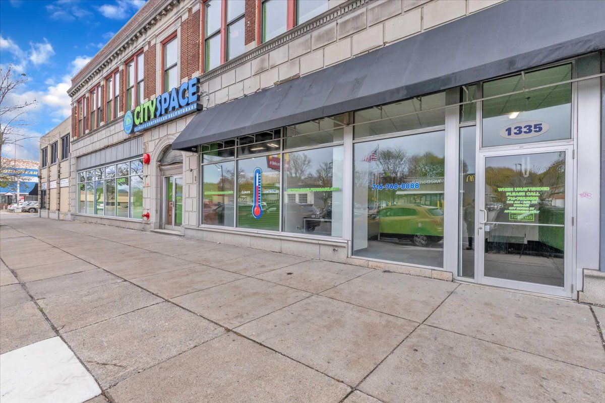 Exterior view of a CitySpace store at 1335 with a black awning and large glass windows.