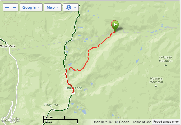 Map showing a hiking trail marked in red, from a trailhead to a mountain peak; green route follows a road.