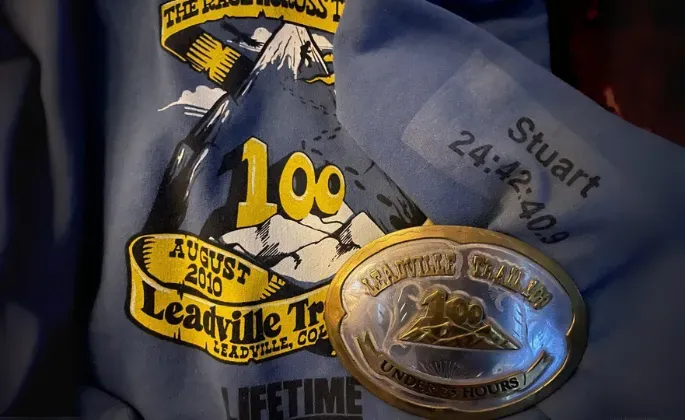 Blue Leadville Trail 100 shirt, medal, and bib with 24:42:40.9 time, commemorating Stuart's finish.