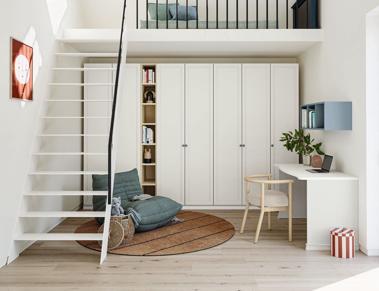 Loft con scale bianche, armadio, scrivania e zona soggiorno con tappeto.