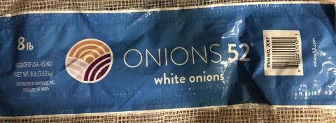 A bag of white onions is sitting on a table.