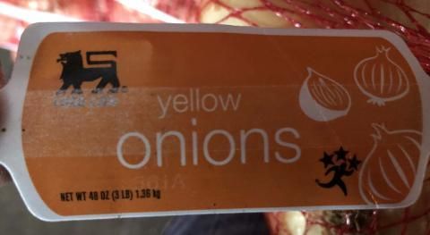 A bag of yellow onions with a label that says yellow onions