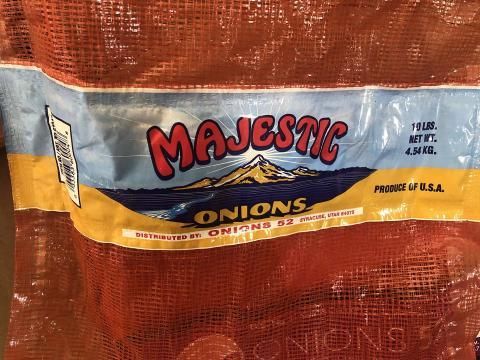 A bag of majestic onions is sitting on a table.