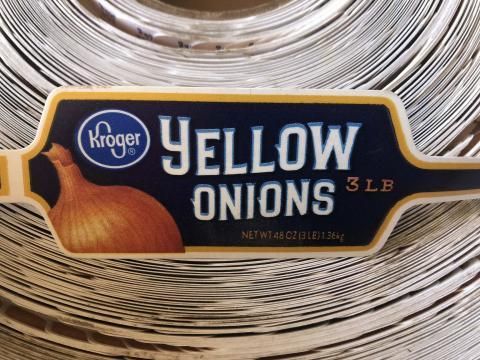 A close up of a kroger yellow onions label