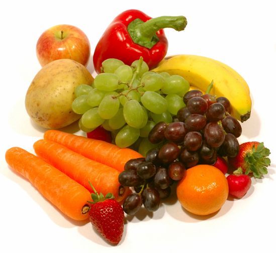 A bunch of fruits and vegetables on a white surface