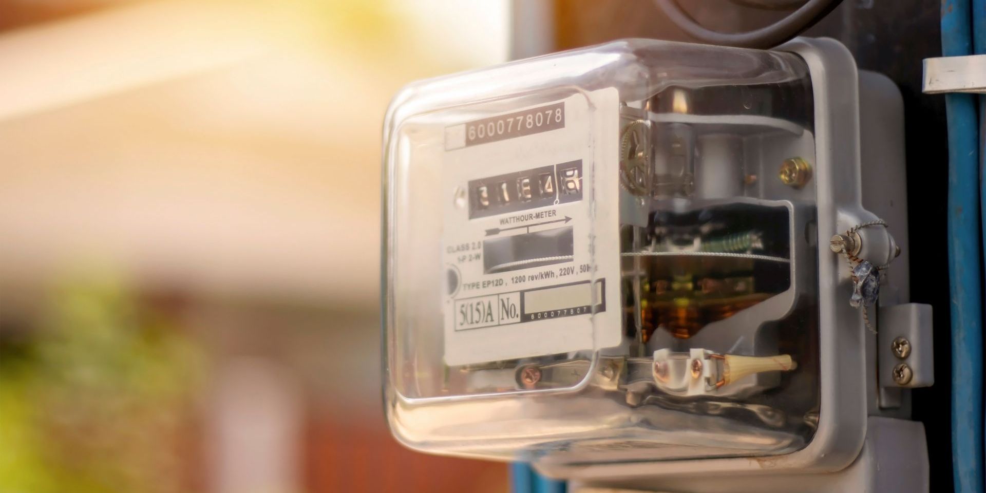 A close up of an electric meter on a pole.