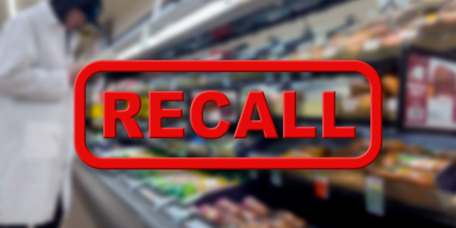 A red sign that says recall in front of a refrigerator