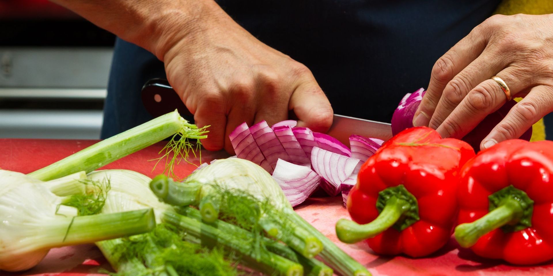 A person is cutting vegetables on a cutting board.