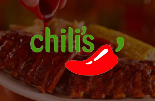 A person is pouring sauce on ribs at chili 's