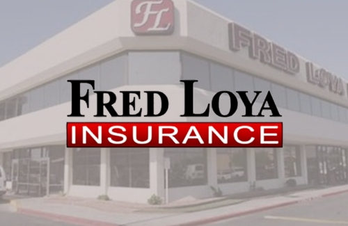 A fred loya insurance logo with a building in the background