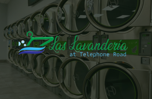A row of washing machines in a laundromat.