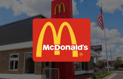 A mcdonald 's logo is displayed in front of a mcdonald 's restaurant