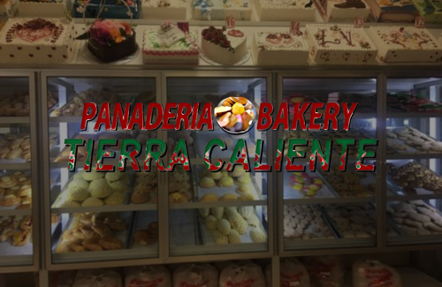 A bakery display case filled with a variety of pastries and cakes.