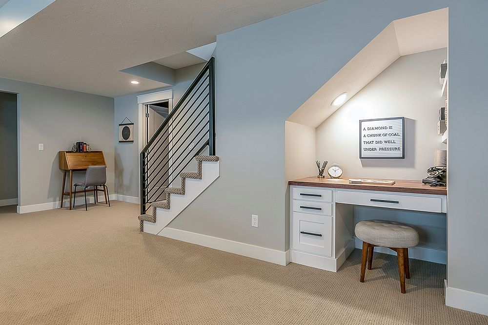 There is a desk under the stairs in the basement.