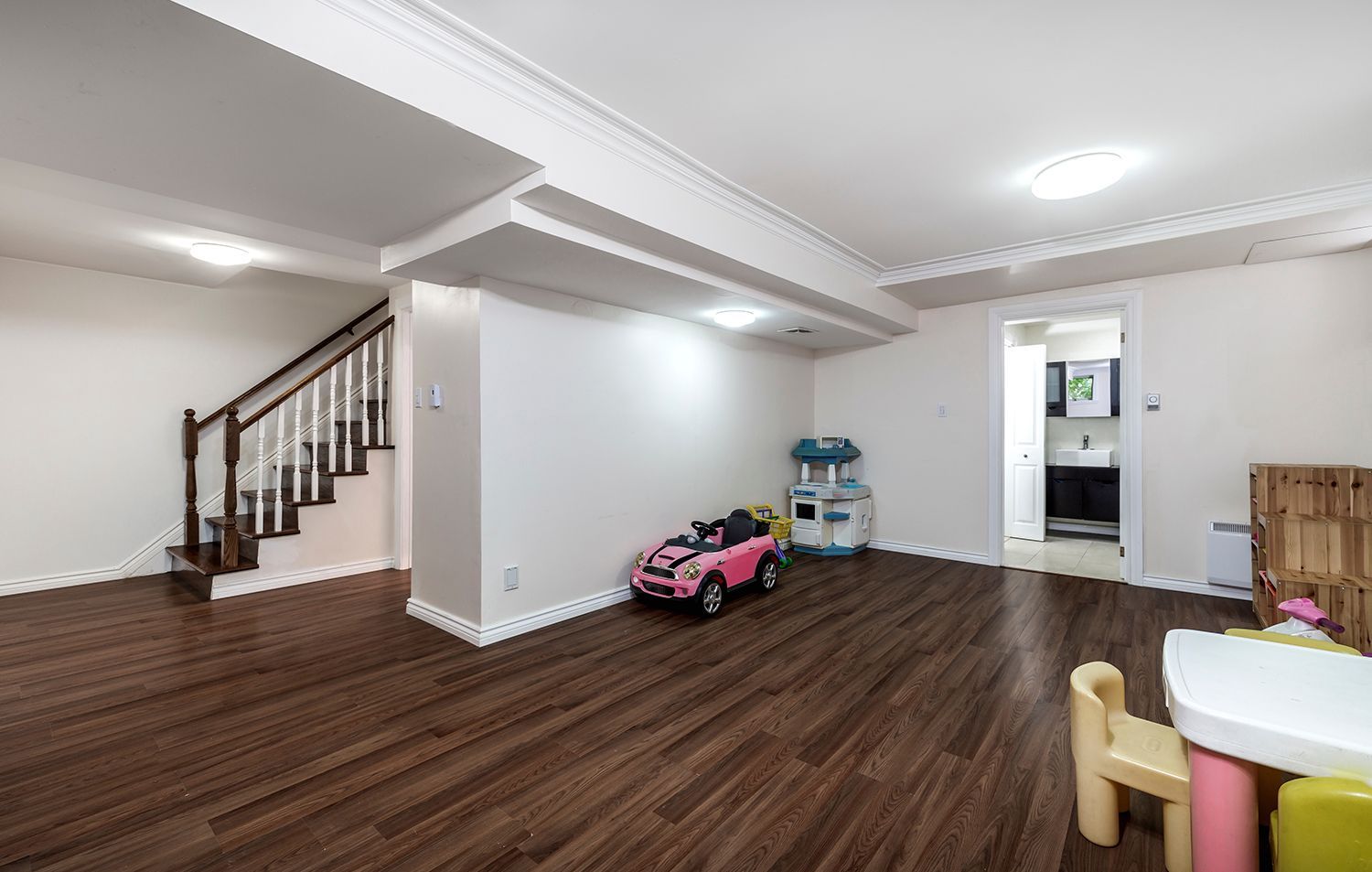 There is a toy car in the middle of the room.