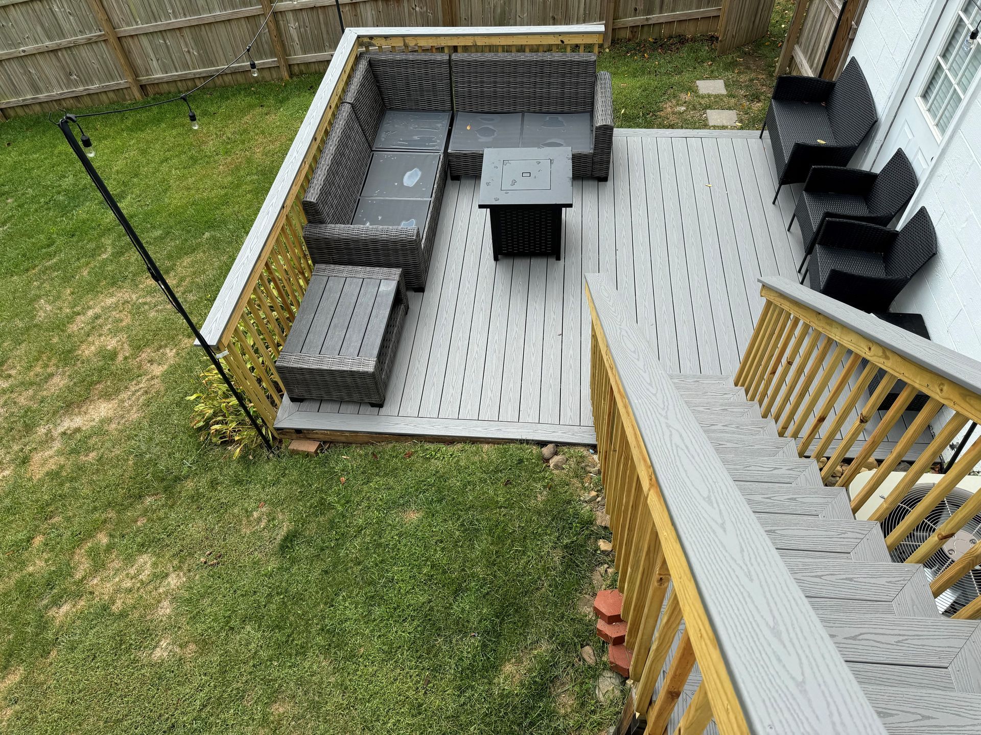 An aerial view of a patio with a sectional couch and chairs.