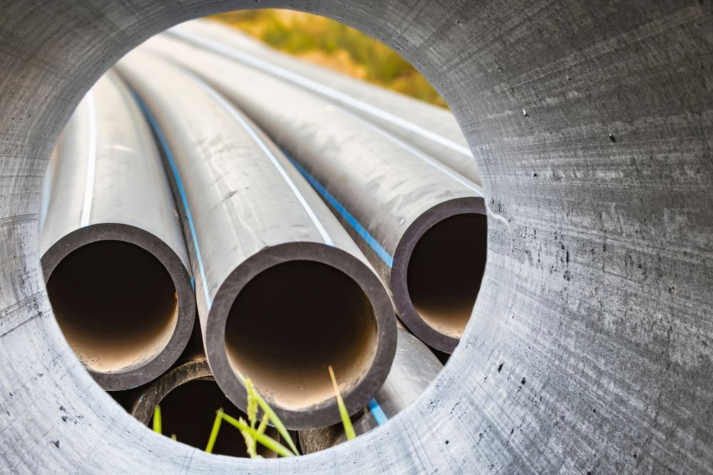 A bunch of pipes are stacked on top of each other