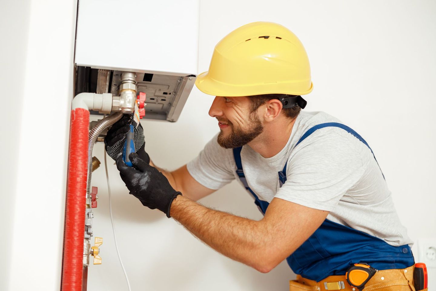 Plumber making repairs to a water heater
