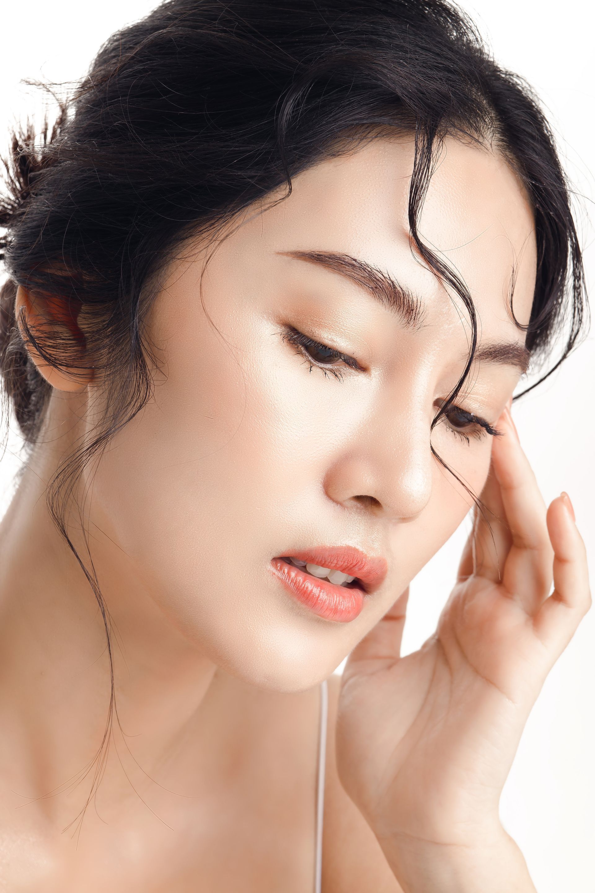 A close up of a woman 's face with water on her face.