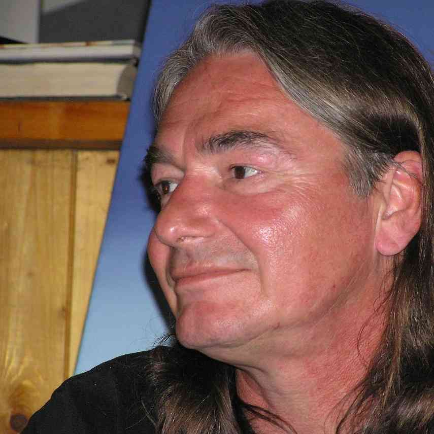 A close up of a man 's face with long hair