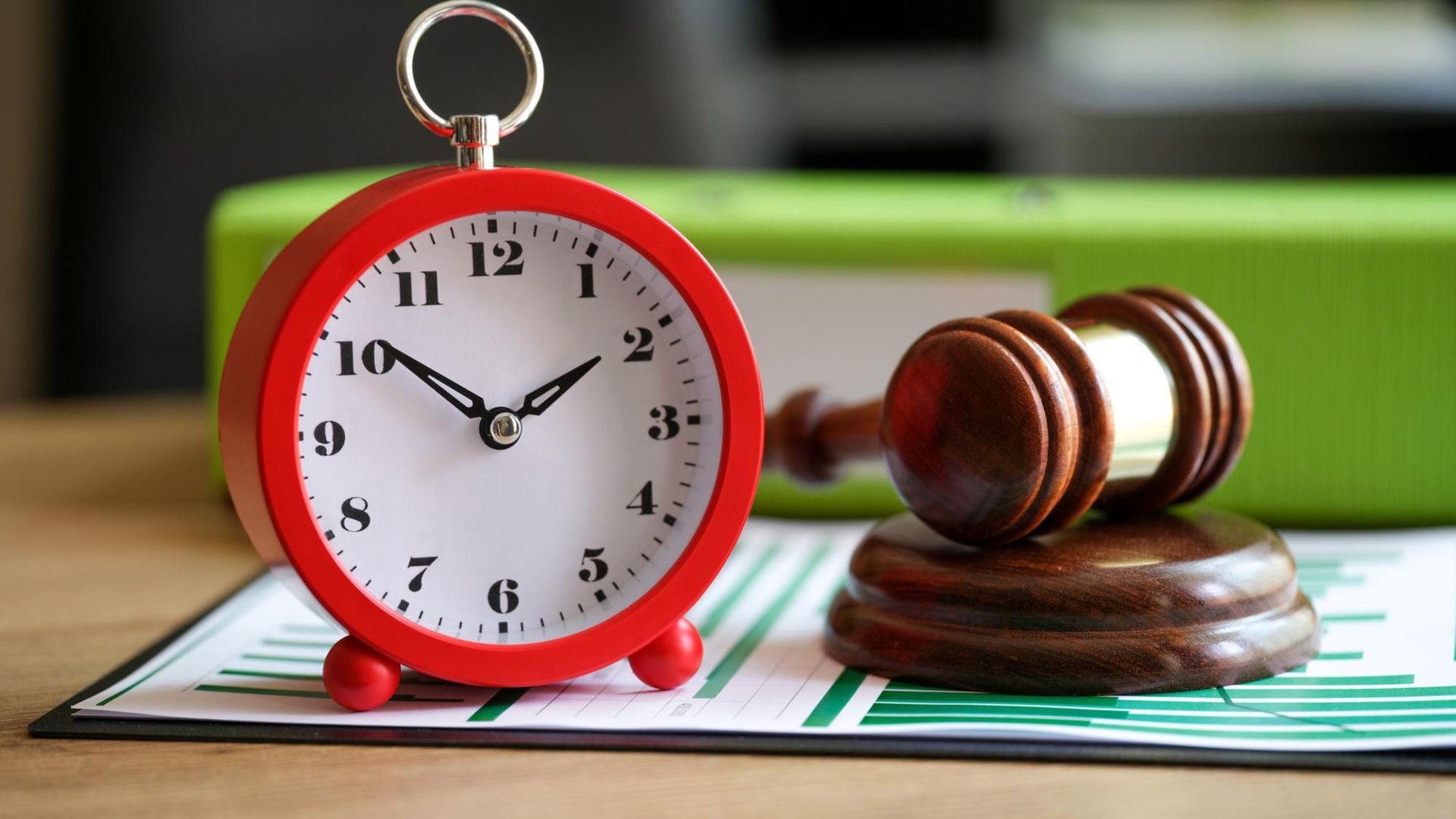 closeup-judges-gavel-with-alarm-clock-financial-documents-postponement-hearing-trial
