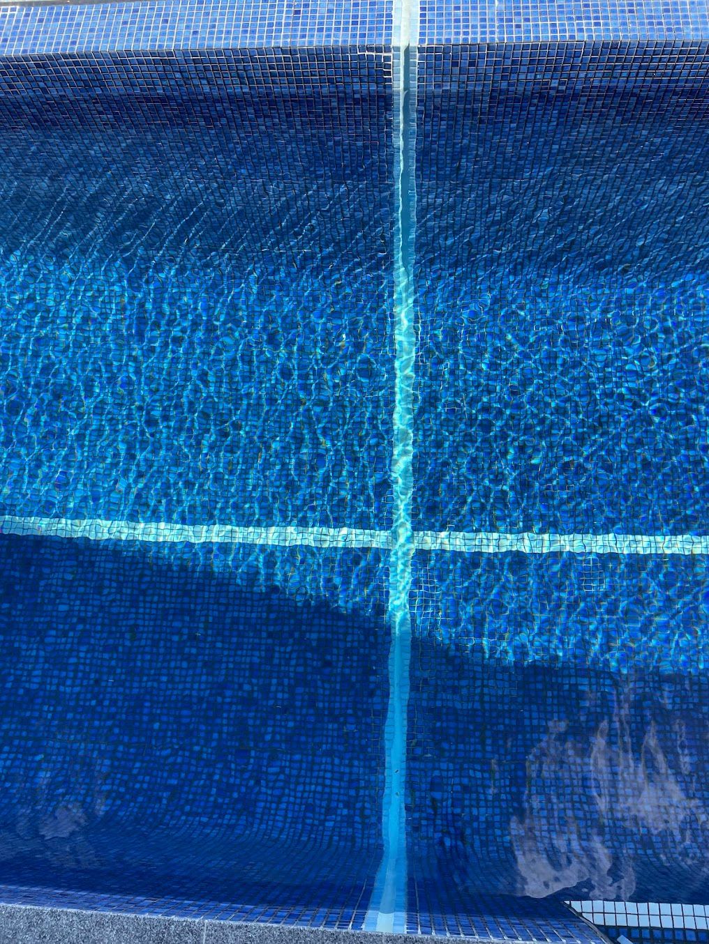 Swimming Pool With Blue Tiles and Lane Lines, Reflecting Sunlight — Leak N Pool In Southport, QLD