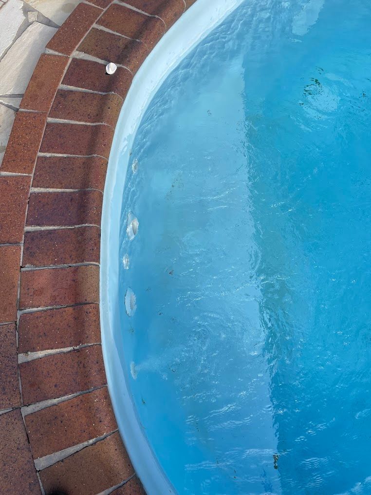 Blue Pool With Bubbly Water, Next to Brown Brick Border — Leak N Pool In Southport, QLD