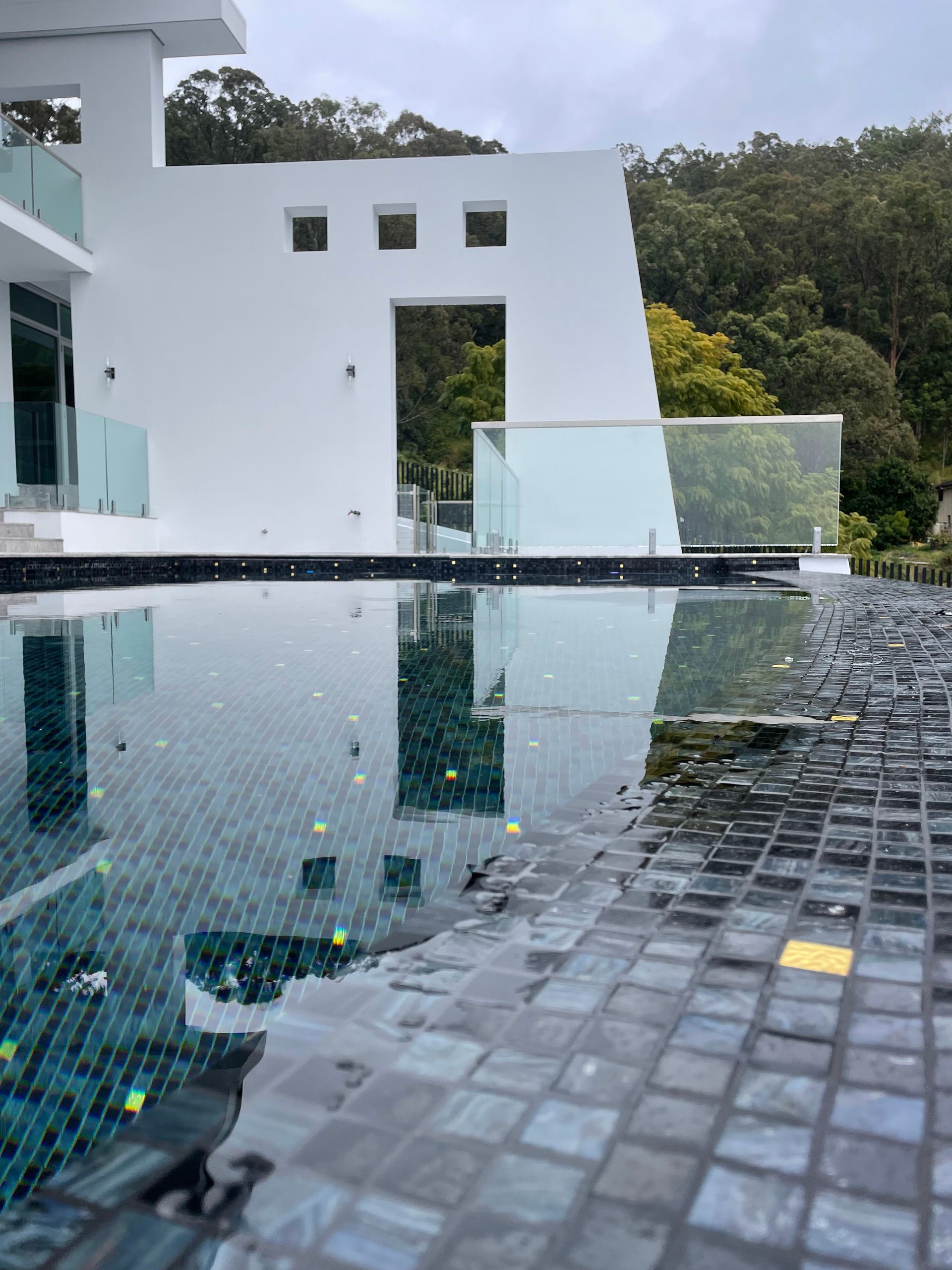 Modern White Building With a Pool; Reflections and Forest Backdrop — Leak N Pool In Southport, QLD