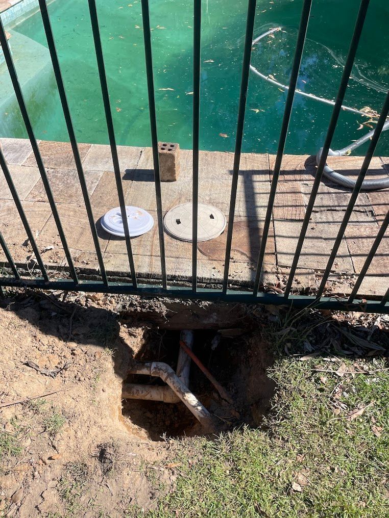 Open Hole Near a Pool, With Fence in the Foreground — Leak N Pool In Southport, QLD