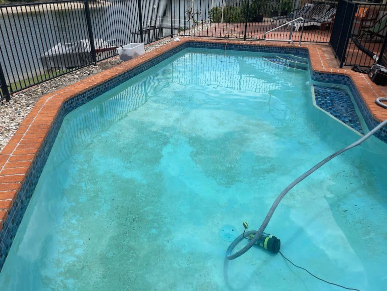 A Swimming Pool With Visible Algae. Greenish-blue Water Surrounded by Brick and Tile — Leak N Pool In Southport, QLD