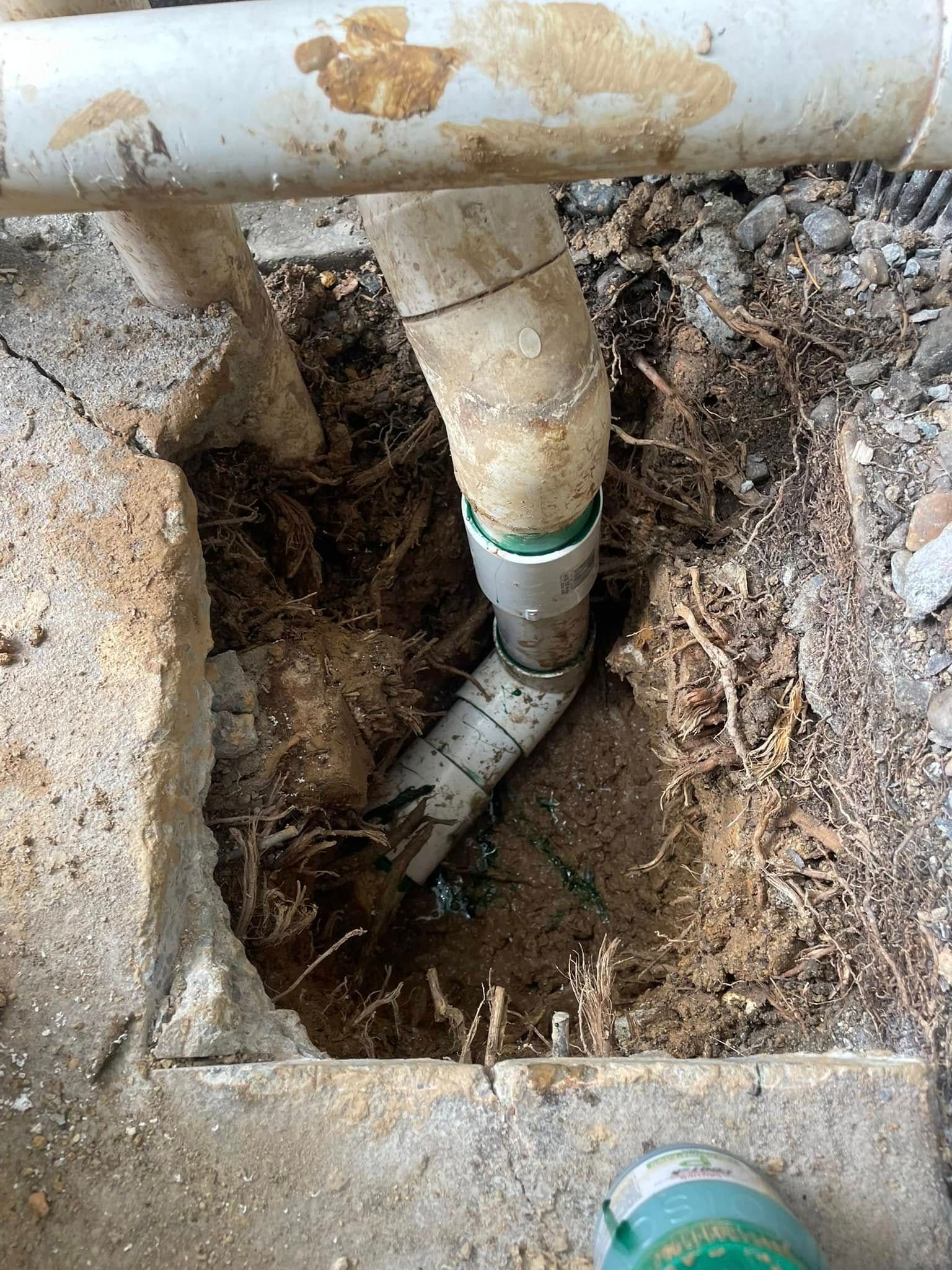 White PVC Pipes in a Hole in the Ground; Visible Roots and Soil — Leak N Pool In Southport, QLD